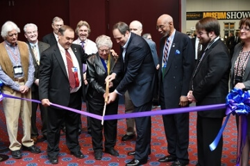 group of people cutting the ribbon at an event