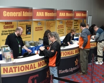 people at admission booths at national money show