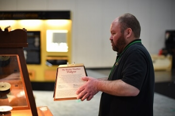 man assembling an a.n.a. display case