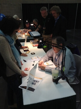 man examining coins at a show