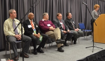 men sitting on stage