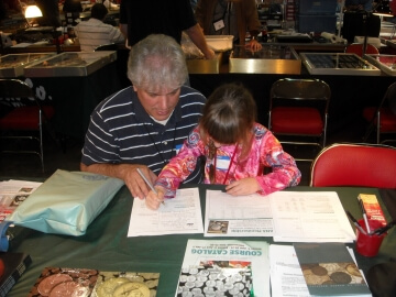 young girl and man looking at papers