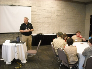 man presenting at the front of a room