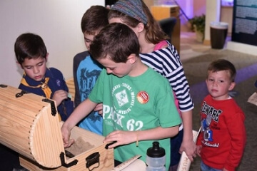 young numismatists digging in treasure chest