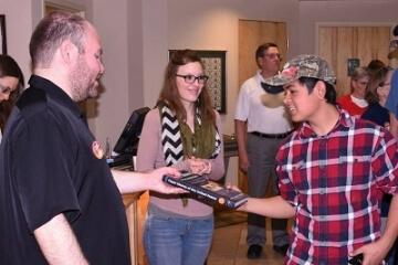 group of people with man holding a book