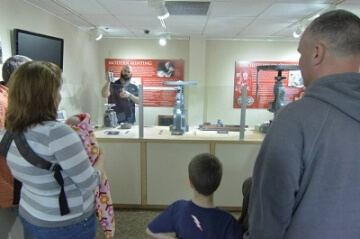 young numismatists watching a demonstration at the money museum