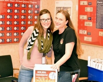 two women posing for national coin week