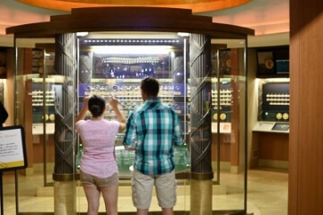 people looking at money museum display