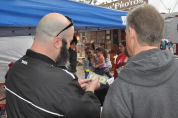 man pointing at dollar bill