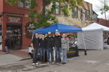 five people standing by a blue tent