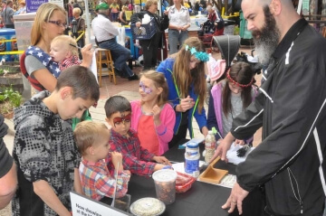 kids at outdoor a.n.a. table