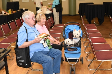 two people sitting in chairs, eating