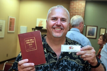 man holding up a book