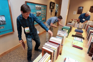 man looking at bookshelf