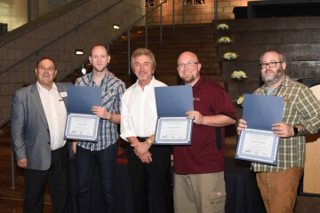 multiple men with awards