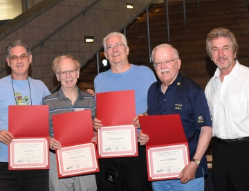 multiple men with awards