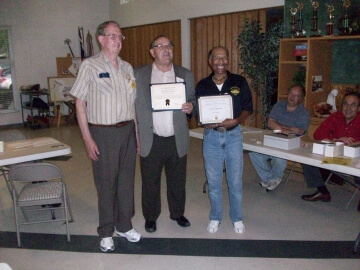 two men with awards