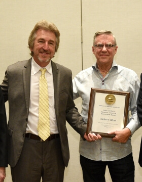 two men with an award