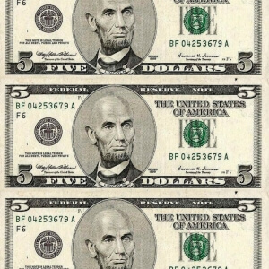 $5 bills with portrait of bald man