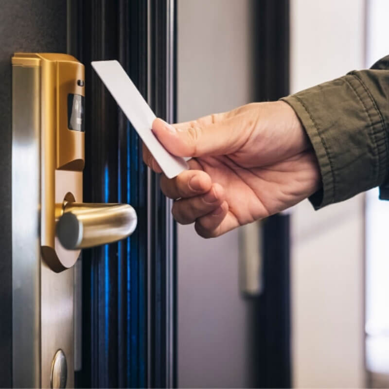 man holding hotel key card
