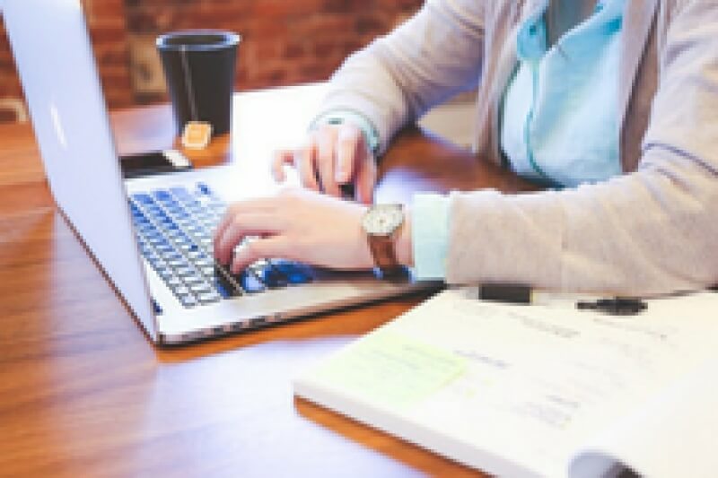 man typing on laptop