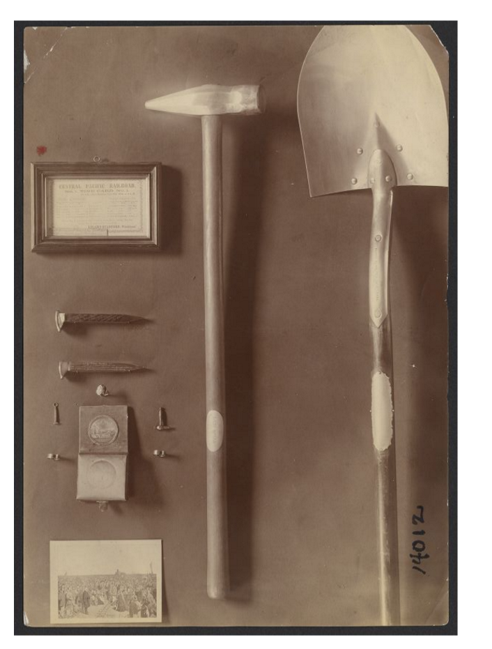 exhibit of items on display including hammer, shovel, medal, rings
